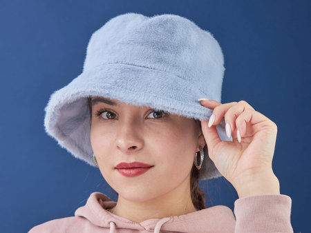 young lady in a panama hat on a blue background