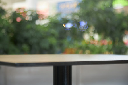 empty cafe table Empty wood table top and blur glass window interior restaurant banner mock up...