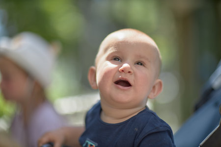 A baby is a happy baby in the first months of life, crawling around the house, smiling.の写真素材
