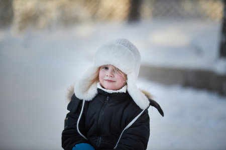 Small Child Wearing Winter Coat and Hatの写真素材