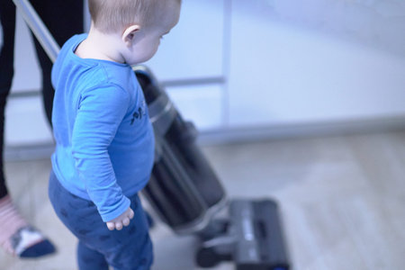 Little boy standing and helping with cleaning.の写真素材