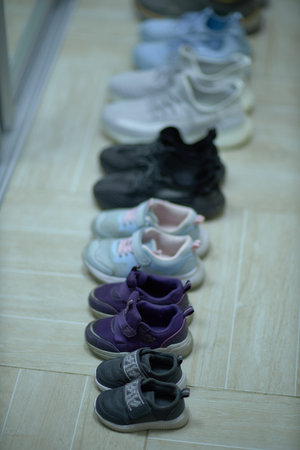 Row of Baby Shoes Lined Up on the Floorの写真素材