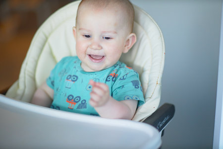 A baby is a happy baby in the first months of life, crawling around the house, smiling.の写真素材