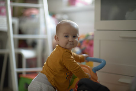 A baby is a happy baby in the first months of life, crawling around the house, smiling.の写真素材