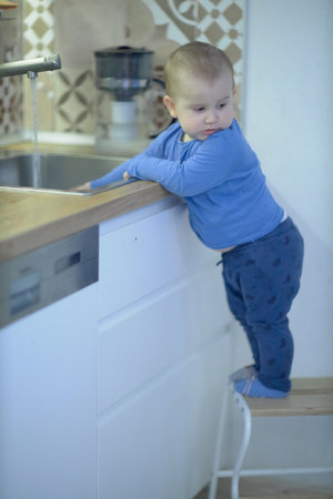 Little Boy Standing on Kitchen Counterの写真素材
