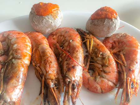 grilled prawns with crumpled potatoesの写真素材