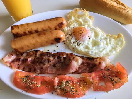 sausage, bacon, tomatoe and fried eggの写真素材