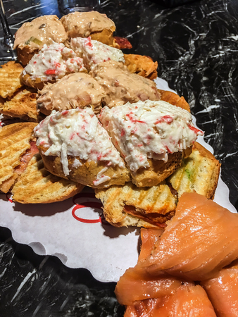 variated sandwich of russian salad, pate, foie, anchovies and salmonの写真素材