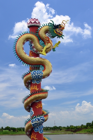 golden dragon on the river and blue skyの写真素材