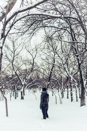 Lonely girl in winter parkの写真素材