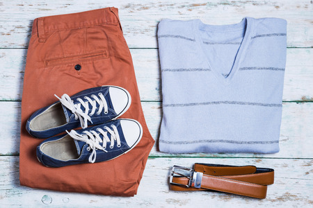 Clothes overhead. Pants, shoes, shirt and belt on white vintage backgroundの写真素材