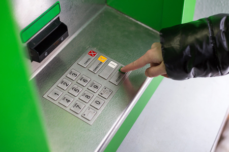 Hand pressing ATM EPP keyboard buttonの写真素材