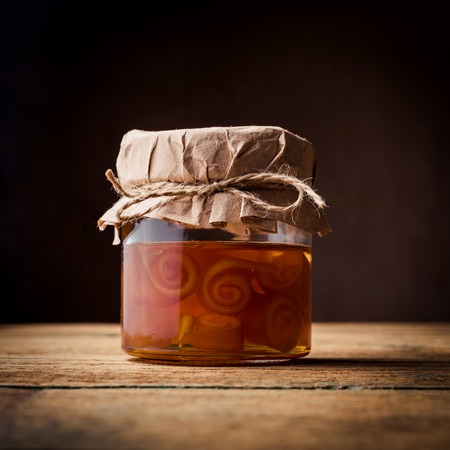 Homemade jars of fruits jam on rustic wooden backgroundの写真素材