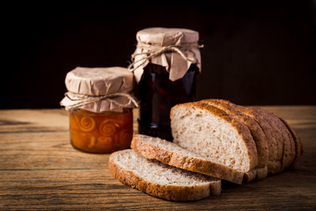 Orange jam in jar on wooden backgroundの写真素材