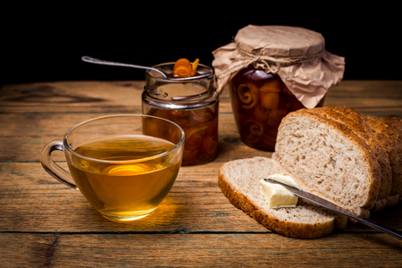 Orange jam in jar on wooden backgroundの写真素材