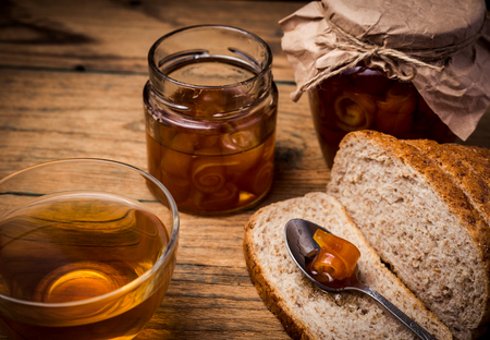 Orange jam in jar on wooden backgroundの写真素材