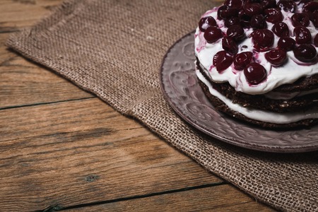 Creme brownie cake with ground cherry on a wooden boardの写真素材