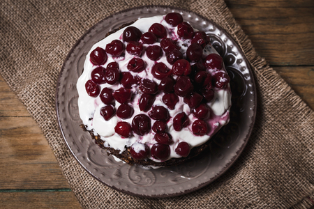 Creme brownie cake with ground cherry on a wooden boardの写真素材