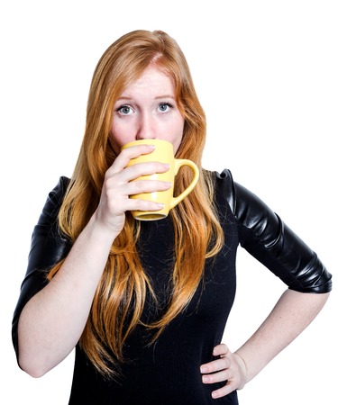 Portrait of a girl drinking from cup isplated on white backgroundの写真素材