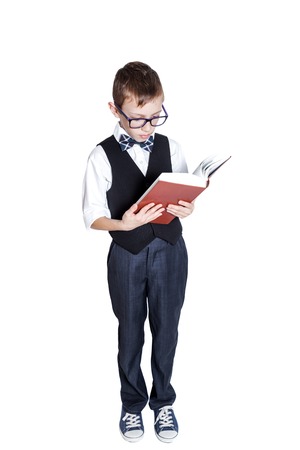 Schoolboy in glasses with book isolated on white backgroundの写真素材