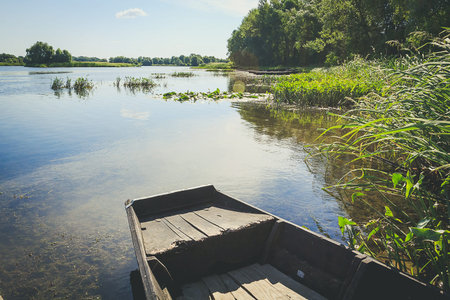 Old boat at the river bankの写真素材