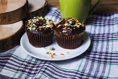Cappuccino and chocolate cupcakes on wooden backgroundの写真素材