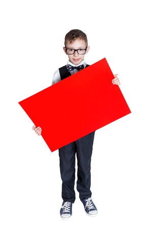 Boy holding a red banner isolated on white backgroundの写真素材