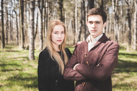 Stunning sensual outdoor portrait of young stylish fashion couple in forest at springの写真素材