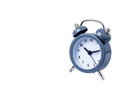 Metal Alarm clock work time on white background 10 am.