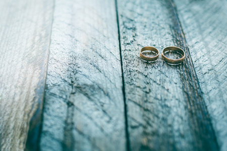 Wedding rings on a  old wooden backgroundの写真素材