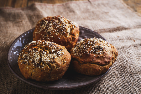 Freshly baked homemade bread on rustic dark wooden backgroundの写真素材