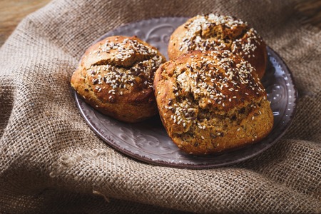 Freshly baked homemade bread on rustic dark wooden backgroundの写真素材