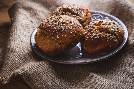 Freshly baked homemade bread on rustic dark wooden backgroundの写真素材