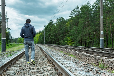 A man walking on the tracksの写真素材