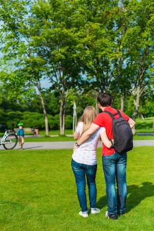 Happy couple holding hands in spring parkの写真素材