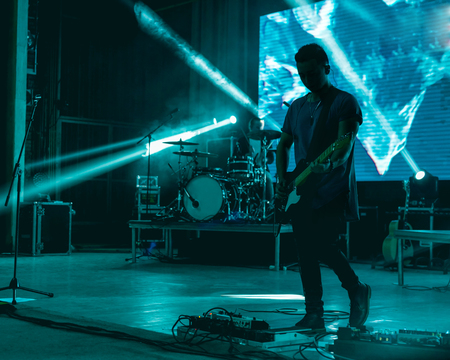 Blurred background light on rock concert with silhouette of musiciansの写真素材