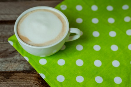 Hot cuppuccino on a wooden table for breakfastの写真素材