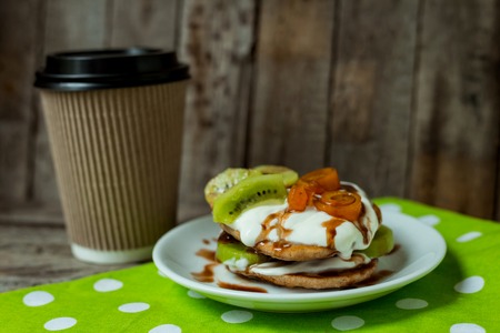 Hot coffee with puncakes on a wooden table for breakfastの写真素材