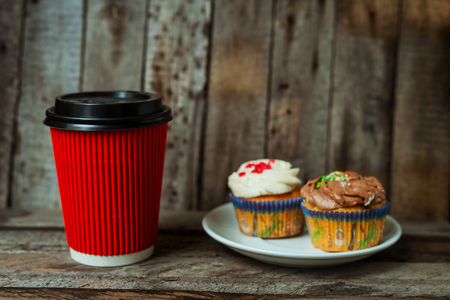 Hot coffee with cupcakes on a wooden table for breakfastの写真素材