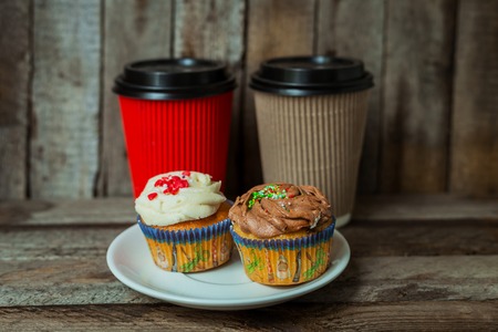 Hot coffee with cupcakes on a wooden table for breakfastの写真素材