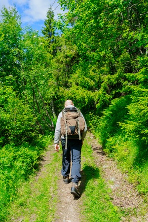 hiker with backpack traveling in Norway mountainsの写真素材