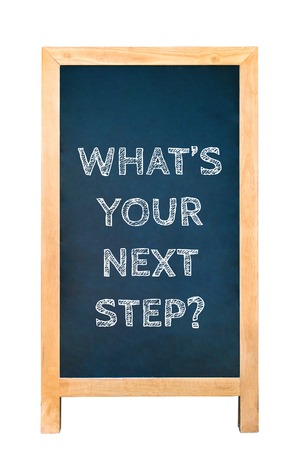 What's your next step text message on wood frame board on wood table, business conceptの写真素材