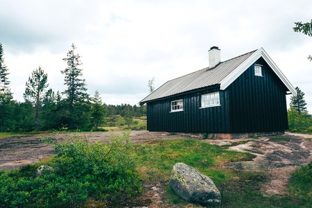 Cabin on a rocky hill in mountaines, Norwayの写真素材