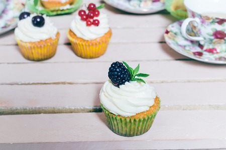 Delicious cupcake with berries on table close upの写真素材