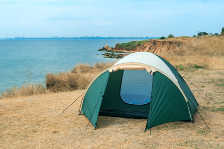 Modern tourist tent on meadow near seaの写真素材