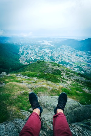 Guy sitting on a rock in the mountains in Norwayの写真素材