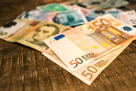 Variable banknotes on wooden top table, currency exchange, currency war