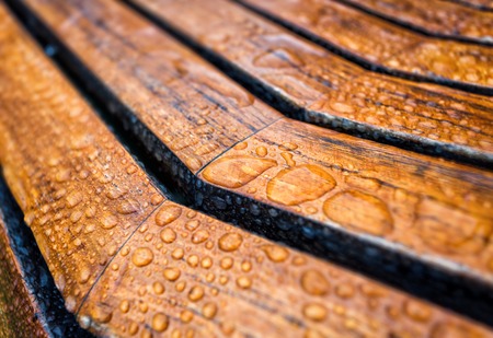 Drops of water on a wooden bench. After rainの写真素材
