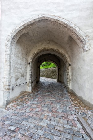 Ancient arch pathway in Tallinn old town in Estoniaの写真素材