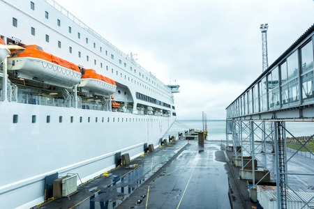 Luxury cruise ship sailing from port on sunriseの写真素材